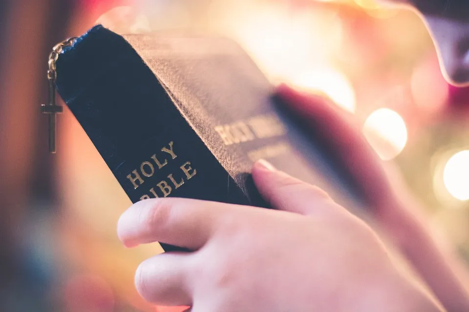 Holding Holy Bible